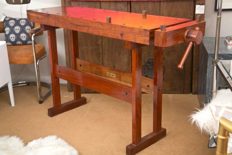 Manufactured by Garrett Wade and made from very beautiful and finely grained Rhodesian Teak, this workbench has simple Industrial design with a multitude of uses. Finished off with glass on top, this would make a unique Console, Standing Bar or Sofa