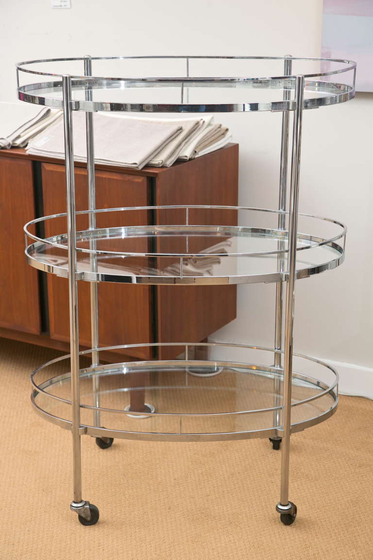 Great looking and super useful mid-century tri-level chrome barcart. All original and in very good condition. Note the top shelf is bar height.