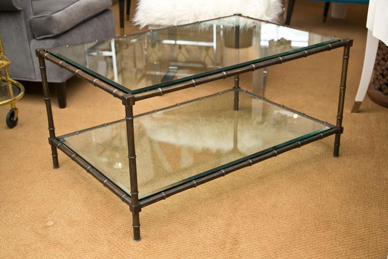 Double tiered, faux bamboo cocktail table with an unusual all-over mottled copper patina. Both glass tiers are original and fully beveled.