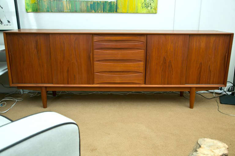 Sensational 1962 sideboard/credenza made by Dyrlund Furniture, Denmark. Incredibly well designed with beautiful sculptural wood drawer pulls and door handles. Excellent, all original condition, and rarely seen.
