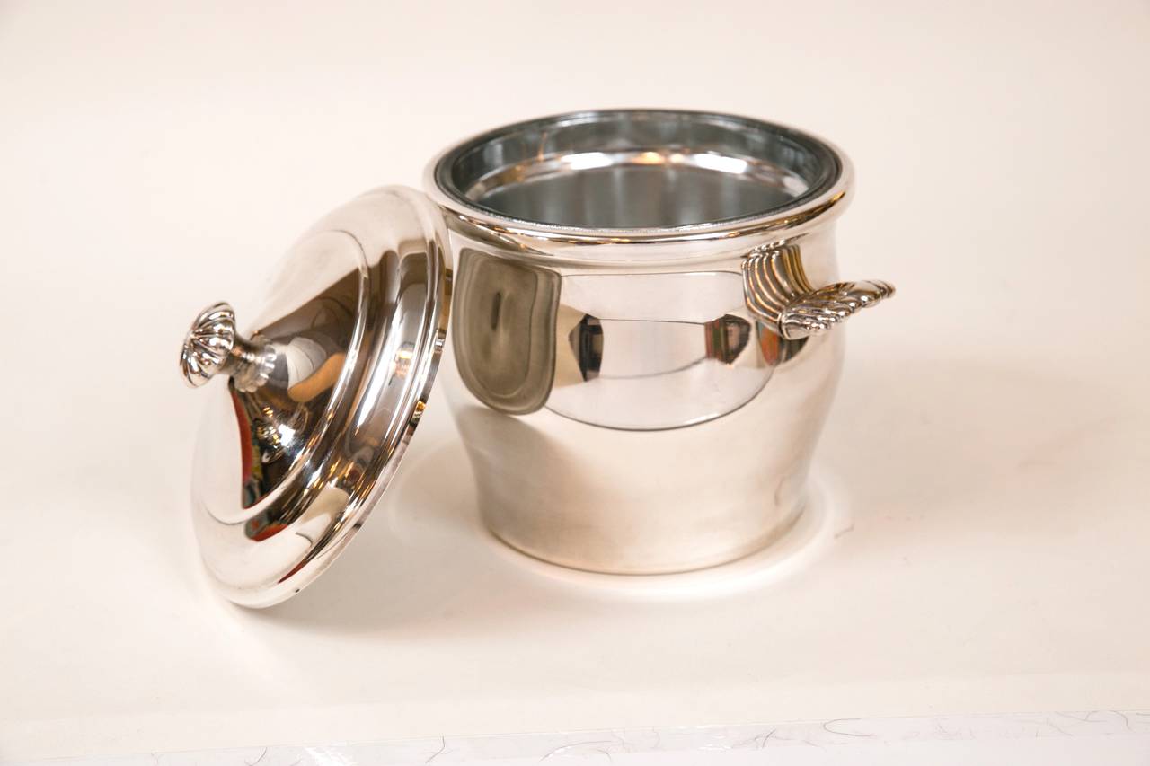 Vintage William Rogers silver-plate ice bucket with heavy mercury backed glass inset. Scalloped handles and lid pull. A beautiful addition to any bar. Stamped with label on bottom.