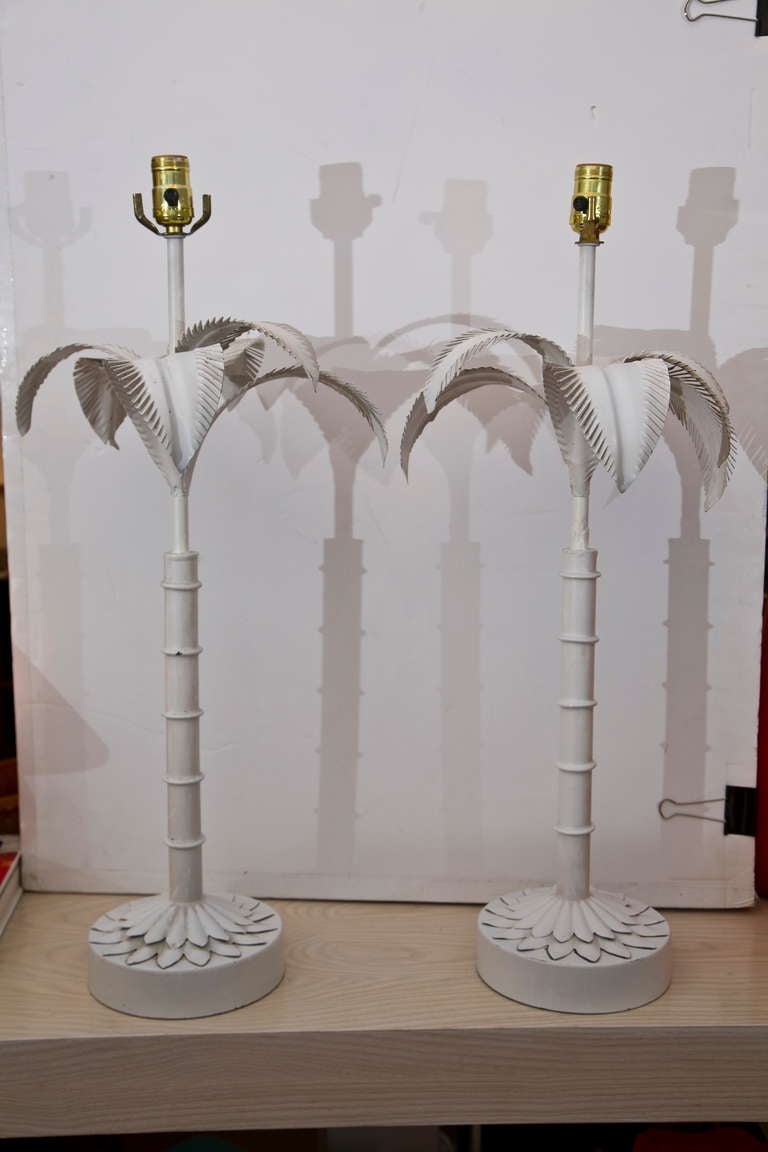 A classic pair of Palm lamps in painted metal. More ornate metal work on base than most. 