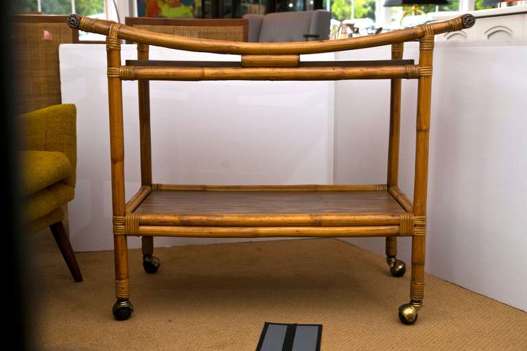 1950's-1960's all original rattan bar cart with two removable wood grain formica panels. 
