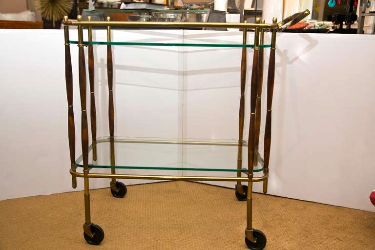 All original 1950's brass and wood bar cart in excellent conditionn Very good over all Vintage patina. Reminiscent of the designs of Cesare Lacca.