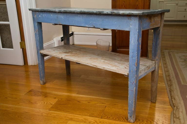All original 19th Century painted potting table with tapered leg and original cornflower blue paint. Age and wear appropriate to such a vintage piece. Paris.