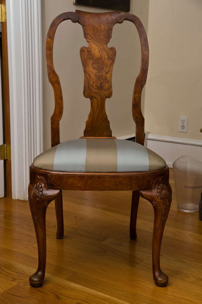 An elegantly constructed and well-carved walnut burl Queen Anne style side chair with pad foot and custom reupholstered seat. Highly figured burl wood. England, third quarter, 19th Century.