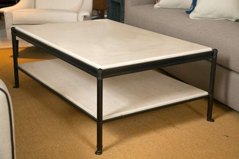 Beautiful proportions and very fine detail work distinguish this bronze finished steel and limestone table. Very much in the manner and style of Billy Baldwin. Excellent condition.