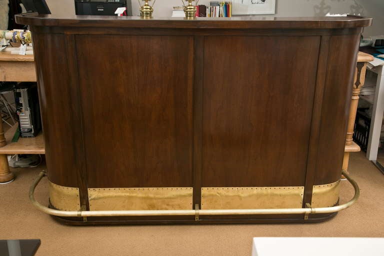 Outstanding all original custom-made 1940's mahogany bar with brass foot rest and kick-plates. Fully fitted interior includes: Locking cabinet with original keys, tin/zinc lined cold storage compartment, dove-tailed cash drawer and bottle/glass