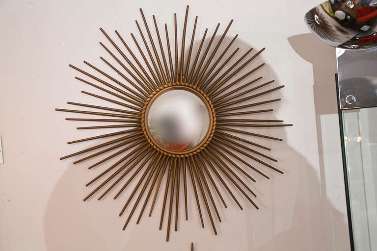 Classic French gilt iron sunburst mirror with convex glass by Chaty Vaullaris