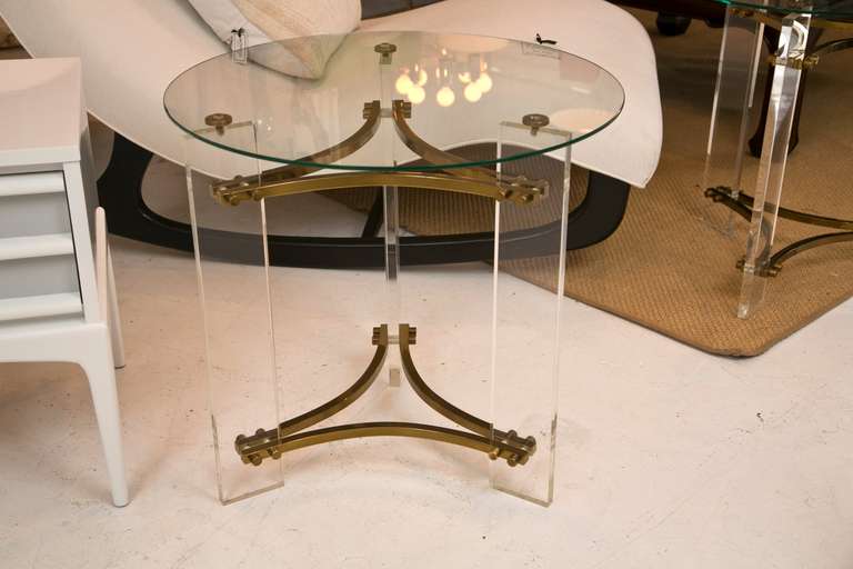 Very desirably sized pair of classic Charles Hollis Jones end tables in Lucite and brass fittings. There are a few scratches on the lucite which do not diminish the beauty of this hard to find pair of tables.