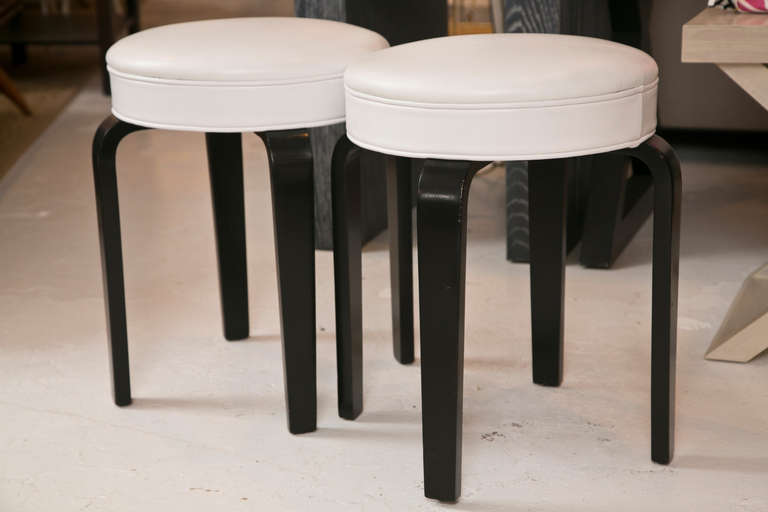 Fine pair of Ottoman/Stools designed in the manner of Alvar Aalto. Custom leather and ebonized legs.