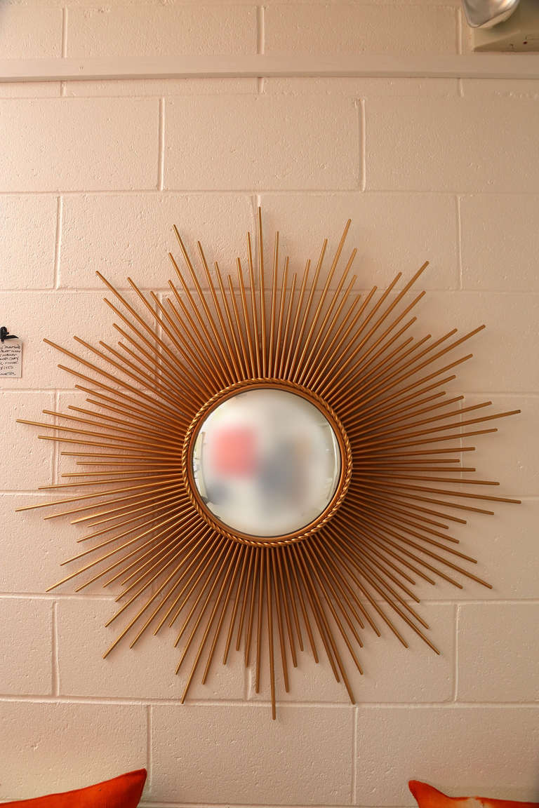 An impressively sized and very well made convex gilt metal Sunburst Mirror that successfully captures the style and essence of the famed Chaty Vaullaris mirrors of the French 1950's.