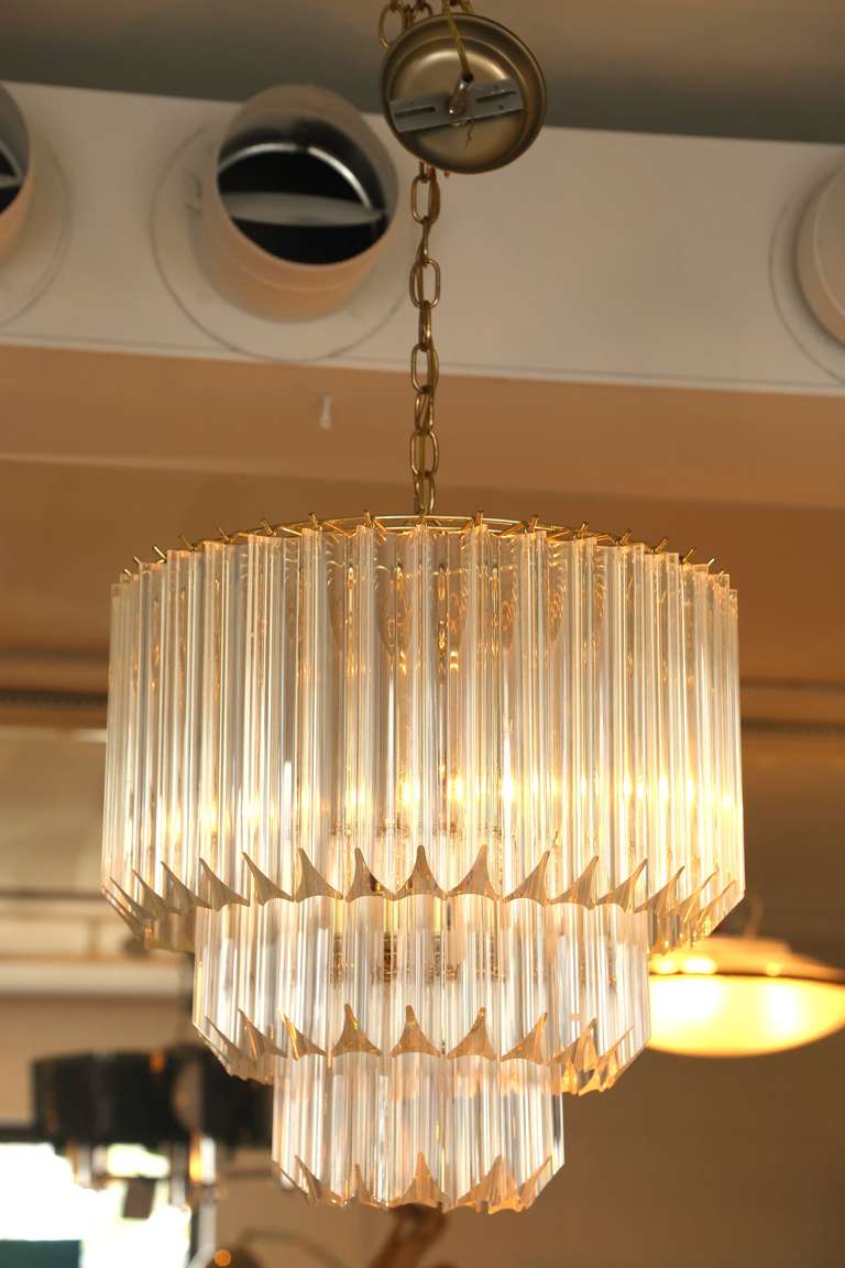 A very fine mid1970s tiered lucite prism chandelier with very good proportions and in excellent condition. This chandelier is an excellent size for a myriad of uses: Dining room, foyer or game room.