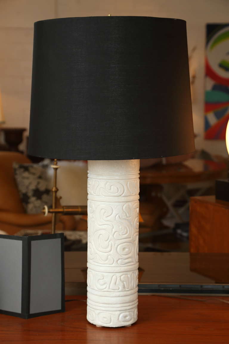 Phenomenal pair of late 1950s sculpted plaster table lamps in excellent condition. Modernistic design motif resembles Mayan Hieroglyphics. Custom shades.