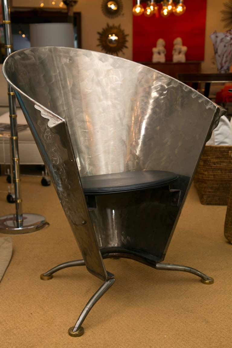 Incredibly comfortable Mid- Century pair of  French steel cafe chairs. All Hand-fashioned of welded metal. Brass cap foot. Custom black leather seat pads. These rarely offered pieces are suitable for several interior applications.
