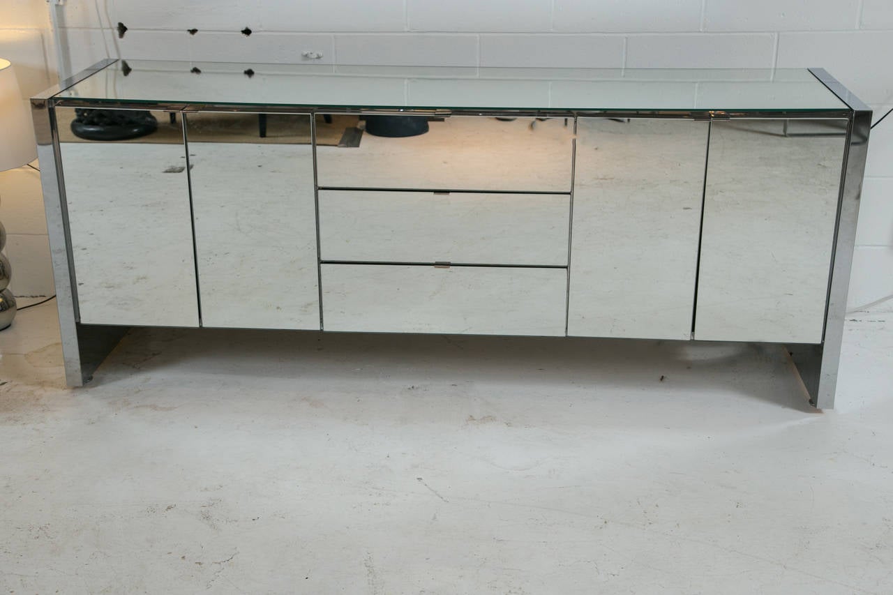 The ultimate statement piece. Stunning minimally designed mirrored dresser by Ello Furniture. Incorporates two side cabinets and three center drawers.