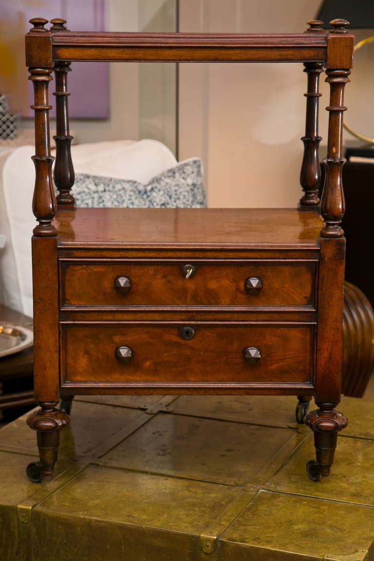 Well made 19th Century Flame Mahogany Canterbury in original condition with well-turned and carved legs, original pulls and castors, and working original key.