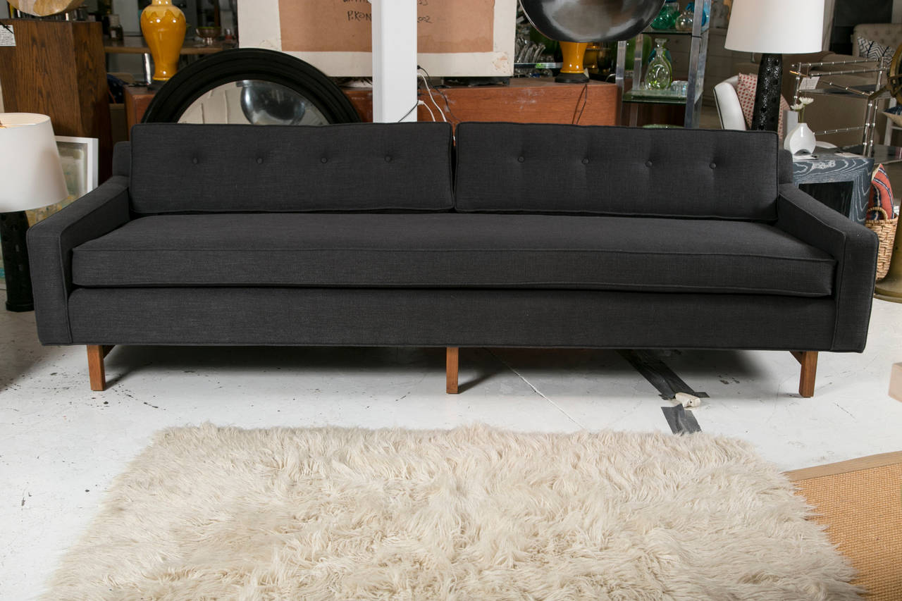 Make a statement with this extra-long sofa by Edward Wormley. We've freshly upholstered this amazing find in a gorgeous charcoal grey microfiber. The sofa has center support due to its length.