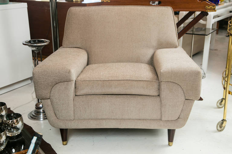 This late 1960's club chair has super space age style and comfort. Turned wood legs with brass cap. May be used with our Metro Modern Sofa. Custom upholstered in a fine quality linen.