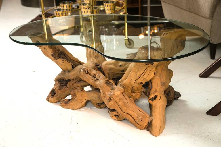 Very cool 1960s driftwood base coffee table. Kidney shaped glass and great age patina on the wood. Excellent proportions.