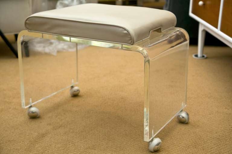 A very hard to find thick lucite castored bench in all original condition. All original.