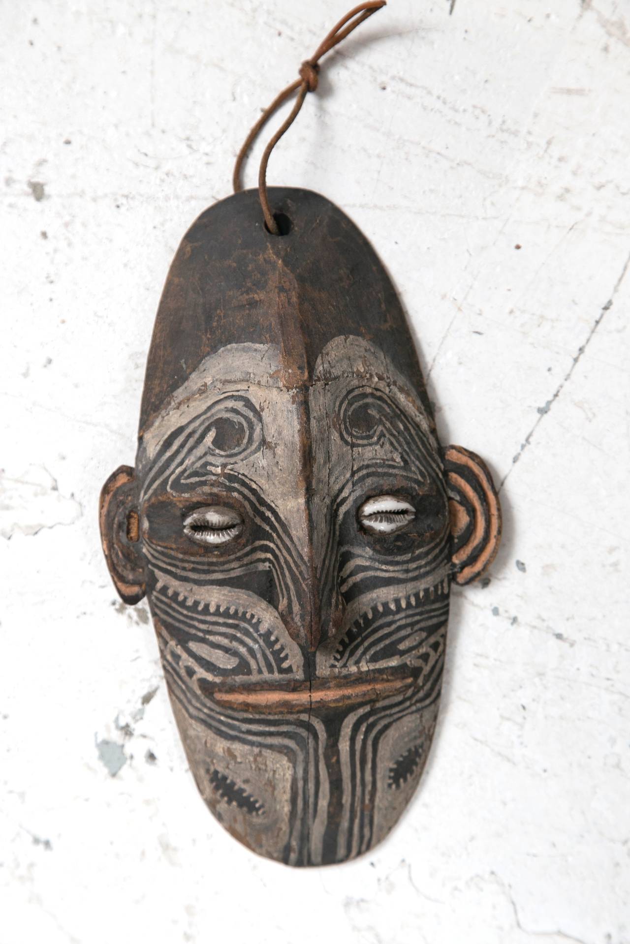 Carved and painted Talisman mask, Sepik River region in Papua New Guinea. Collected in the mid-1960s and in very good condition, with age appropriate wear. Cowrie shell eyes.
