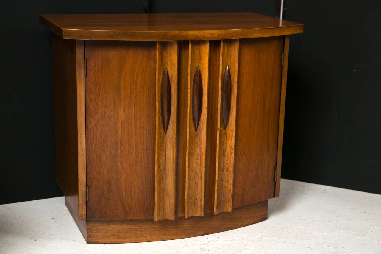 Well-made teak finish pair of 1960s door stands with curved front panels and sculptural contrast finish pulls. Very nicely proportioned, and may be used effectively in any number of interior applications.