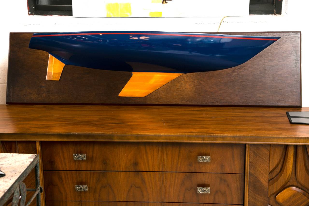 A very well made 1950s-1960s half hull sailboat which has been custom lacquered in a royal blue with red pinstripe. Generously proportioned and eminently suitable for a number of interior projects.
