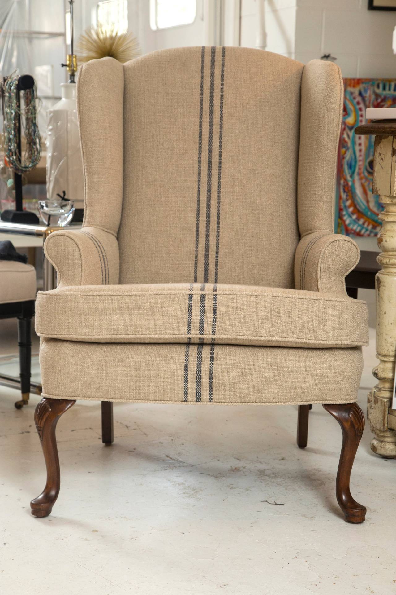 Well made and very comfortable Classic wing chair. Custom upholstered in French ticking. Nicely tailored, and fits nicely in any number of applications.