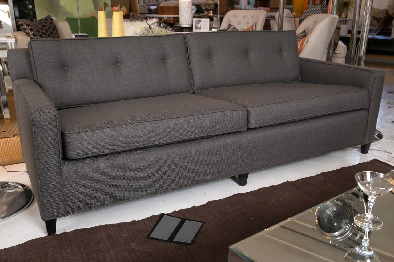 Mid-Century two cushion sofa with excellent proportions. Very well made and custom upholstered in a rich, charcoal linen. Excellent tailoring throughout, with button-tufted back cushions.