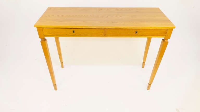 This delicate yet sturdy little desk promises a long life of use in many applications, with two locking drawers and elegant tapered legs.