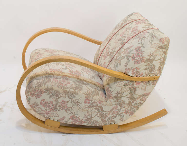 Who can resist the inviting comfort of this cushy, upholstered rocking chair?  Swooping, solid birch, bent and flowing like script in a perfect C! The existing upholstery is serviceable, but re-upholstery is recommended.