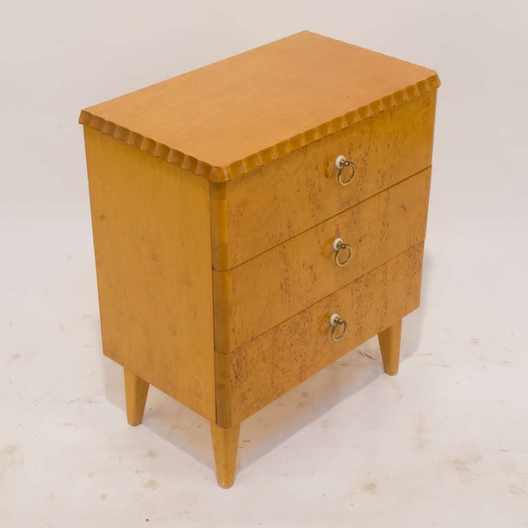 Designed as a bedside table, this three-drawer chest holds everything one might need at a moment's notice without getting up. Smoothly opening drawers are surprisingly deep, with original brass rings with decorative, bakelite washers. Constructed of