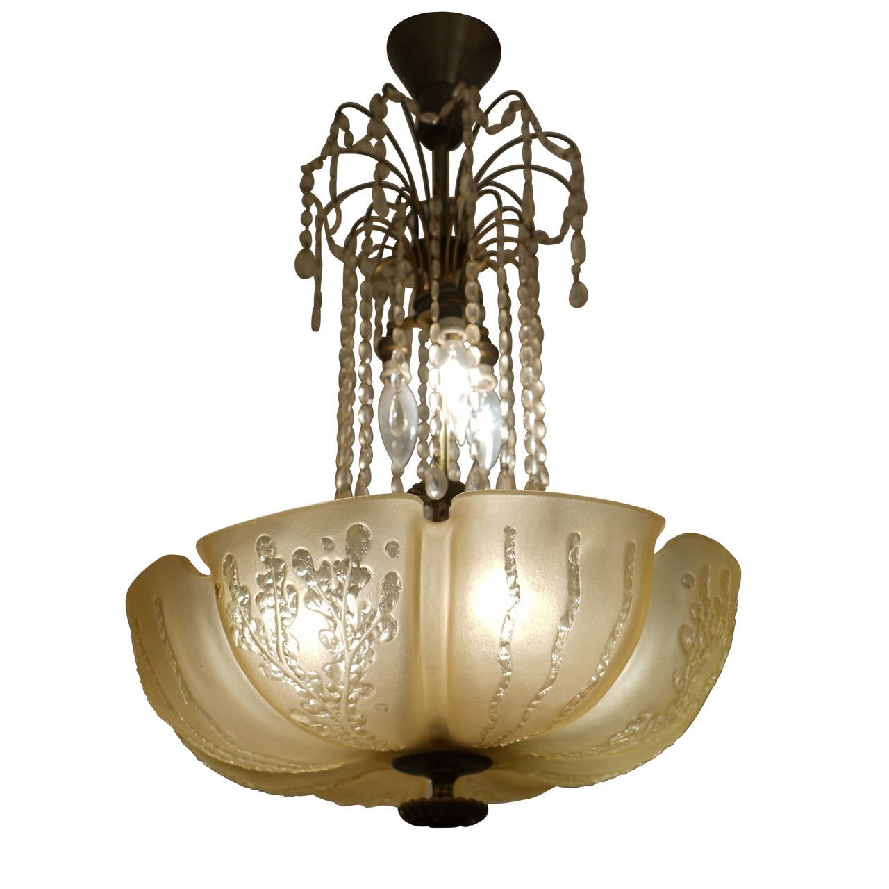 Dripping with crystals, this chandelier is iconic of the decadence of the roaring twenties. A golden blossom with stylized plants and grasses adorning the petals and a waterfall of cascading crystals glitter in the reflection of 7 light bulbs. 