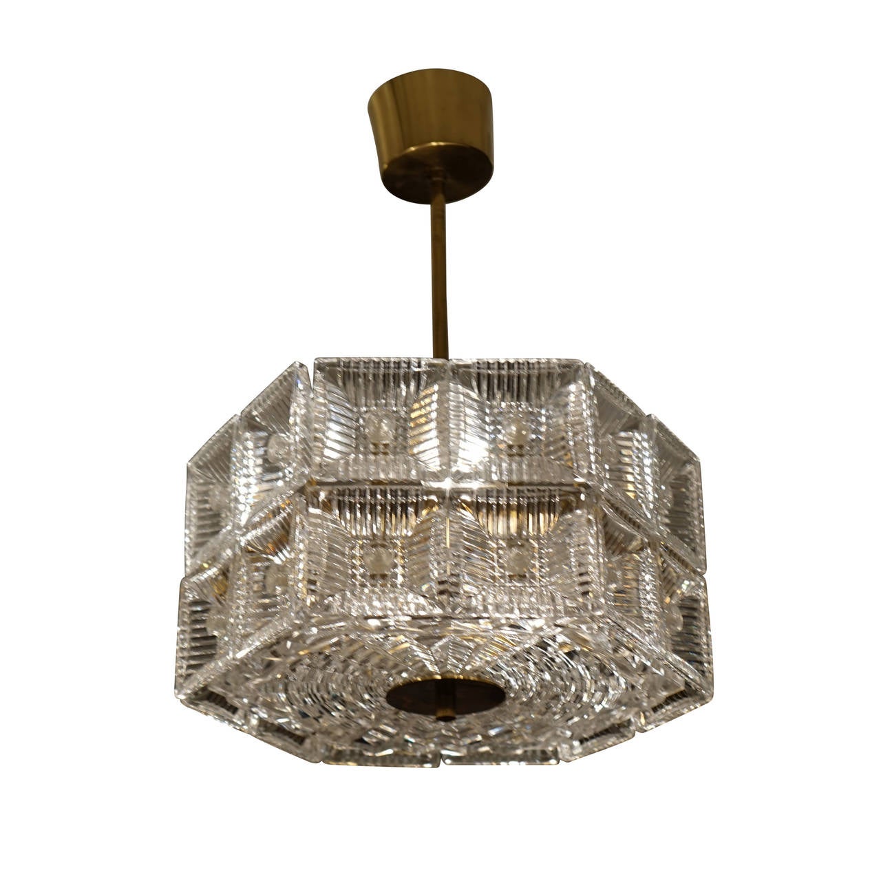 Crisp, bright and quite reflective, this cubist inspired light fixture features 24 inverted pressed glass prisms.  A circular pattern on the base differentiate this piece from the following listing which is otherwise identical.