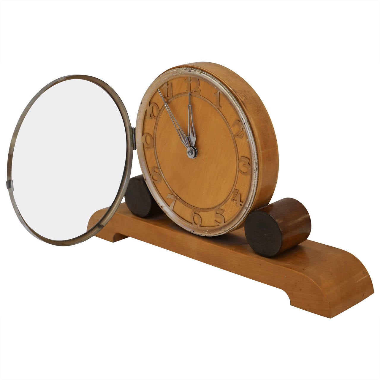 The geometric design and the stylized numbering with concentric chrome banding give this two toned wooden clock pizazz!  The clock runs using the original movement which winds in the back, but needs adjustment by our clock restorer before shipping,
