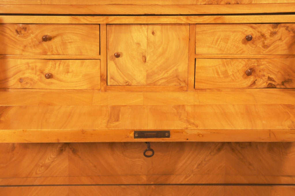 Also known as a lady's desk, this chest was designed to hold jewelry, correspondence and trinkets in its hidden interior drawers. The uppermost drawer pulls out and is hinged to fall flat and create a writing surface.