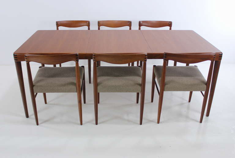 Danish modern dining set designed by H. W. Klein.  Crafted in 1967 from an earlier design.
Rich teak with unique inland joinery.
Table features removable leaf (which conveniently stores under table) providing a maximum overall width of 76.5