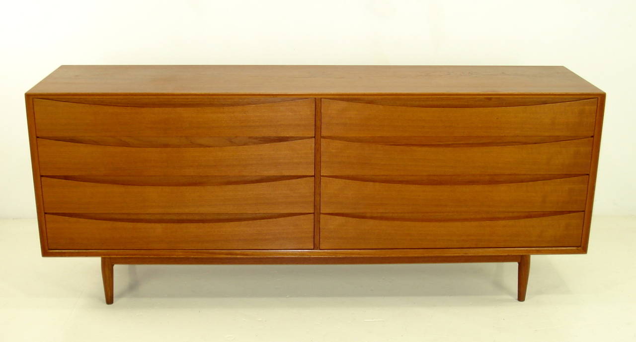 Eight drawer double dresser chest designed by Arne Vodder. 
Sibast, maker.
Beautifully crafted in rich teak. Signature inset, cat eye drawer pulls.
Top left drawer has removable tray.
Finished on the back for 360 degree use.
Professionally