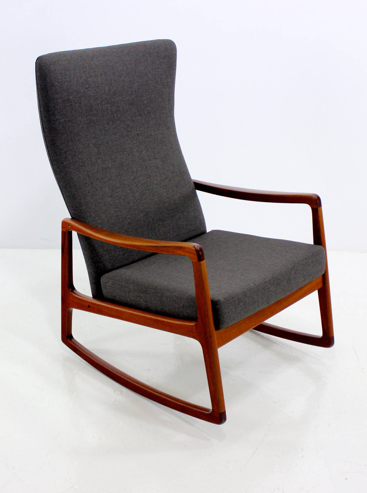 Extraordinary Danish modern rocking chair designed by Ole Wanscher.
Rare high back model.
Teak frame, impeccably upholstered in highest quality period fabric.
Professionally restored and refinished by LookModern.
Matchless quality and