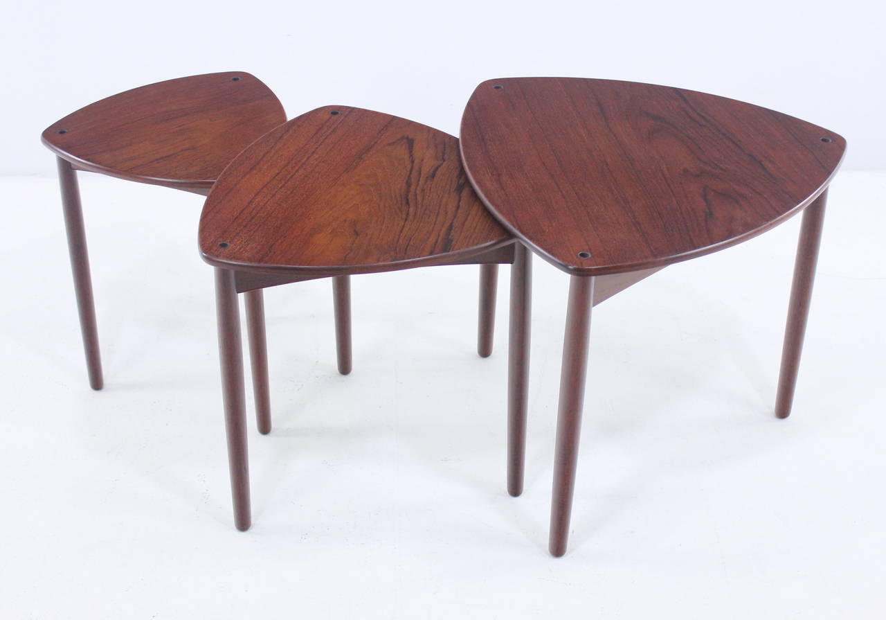 Extremely rare set of three danish modern nesting tables designed by A. Bender Madsen & Ejner Larsen. Willy Beck, maker.
Triangular tops on tripod bases.
Beautifully designed and crafted in richly grained teak.
Modern minimalism at its