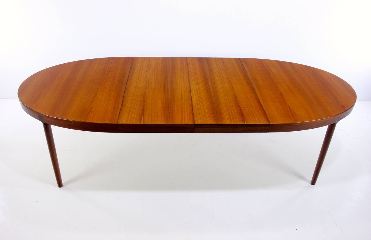 Gorgeous, versatile, Danish modern dining table designed by Harry Ostergaard.
Richly grained teak with extraordinary inlaid joinery on leg tops.
Extra wide skirt on two 19.5