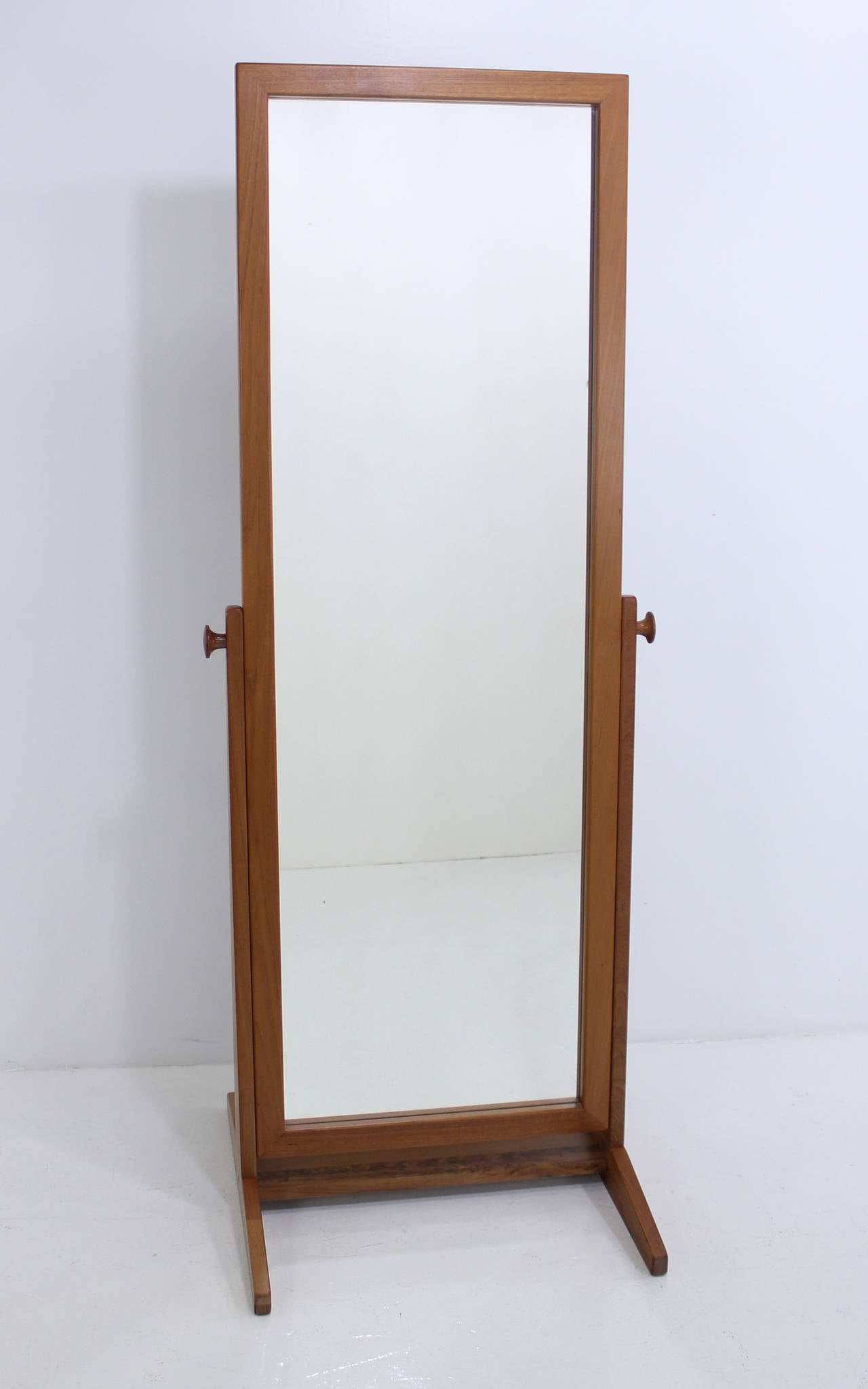 Danish modern full length mirror designed by Pederson & Hansen.
Teak frame and stand.
Side knobs adjust mirror angle.
Professionally restored and refinished by LookModern.
Matchless quality and price.
Low freight and quick ship.