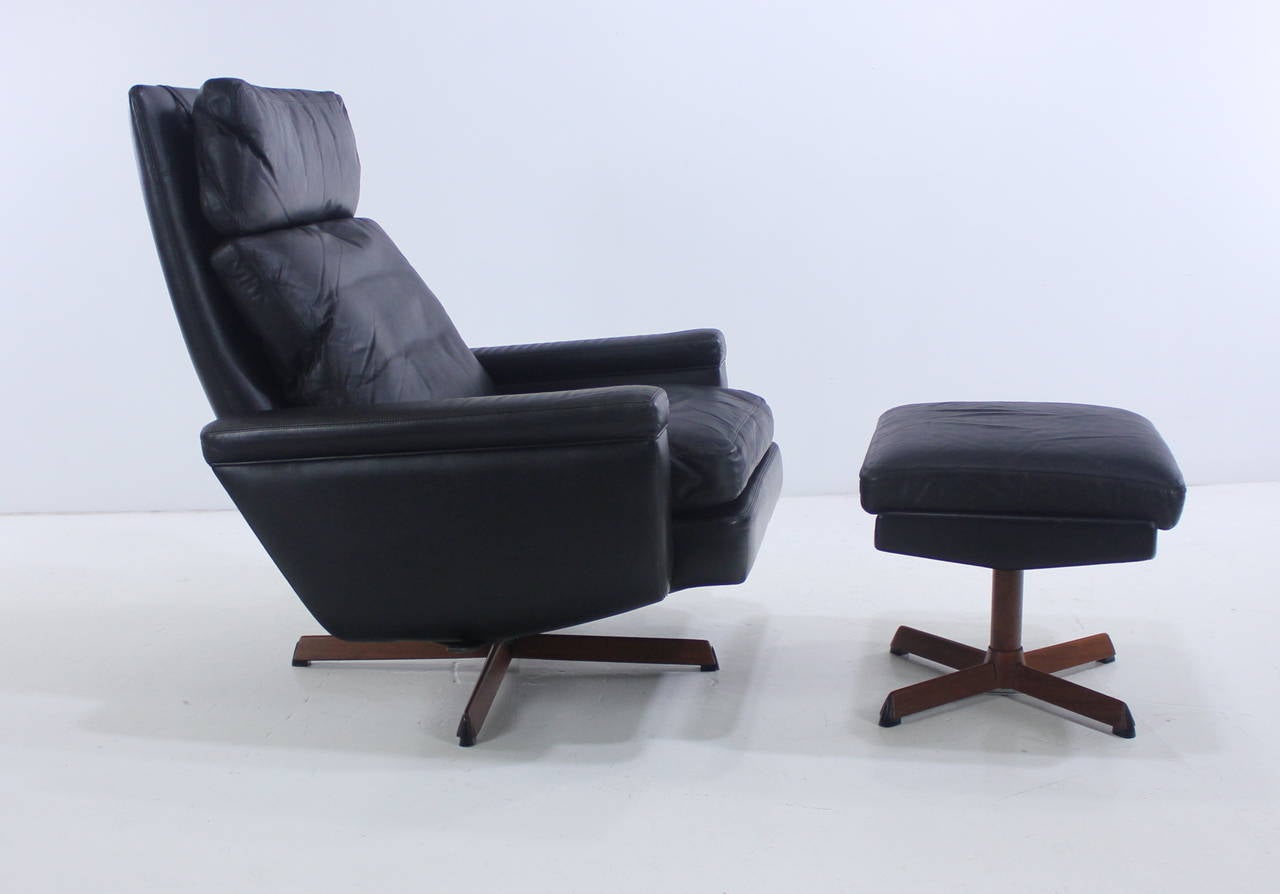Danish modern lounge chair and ottoman designed by Madsen & Schübel.
Superb Scandinavian version of the classic Eames lounge chair and ottoman.
Black leather with solid teak banding. Down cushions provide ultimate comfort.
Chair is stationary or