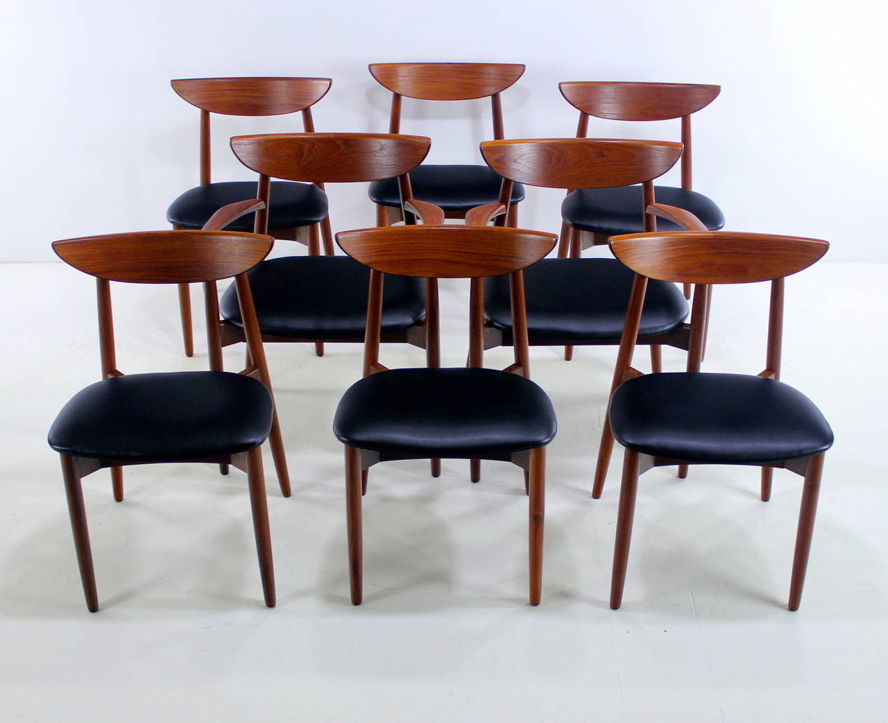 Eight dining chairs designed by Harry Ostergaard.
Six side chairs, two-arm chairs measuring 24