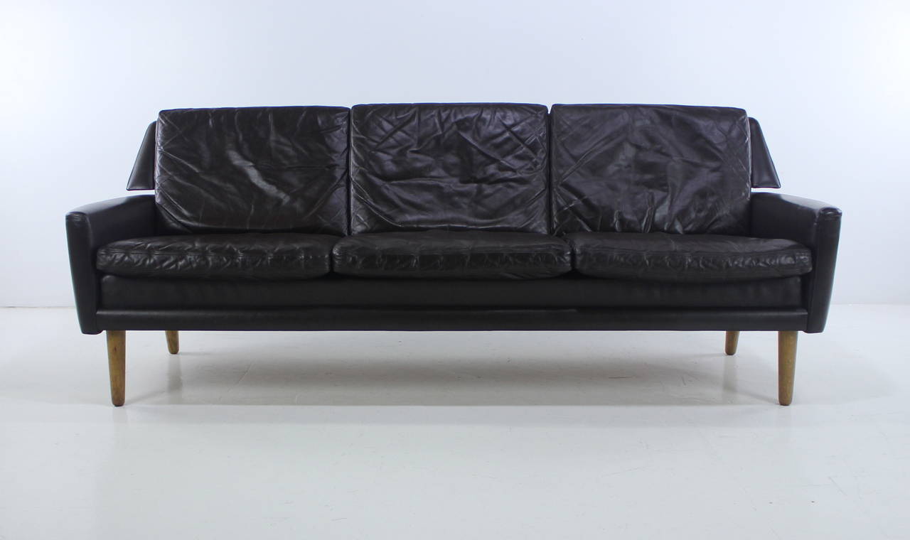 Danish modern sofa designed by Erik Worts.
Rich, dark, espresso brown leather with oak legs.
Slightly rounded armrests. Narrow wings project from back.
Ultimate comfort and style.
Matchless quality and price.
Low freight and quick ship.