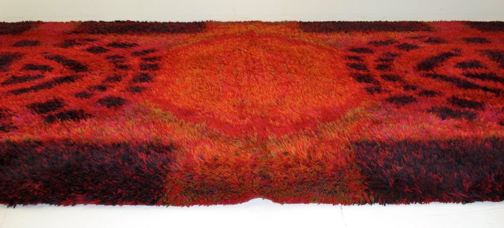 Vibrant Rya rug designed by Ritva Puotila, made by Oy Finnrya.
Entitled "Fireside Evening".
Vivid red field with gold center flanked by pink, burgundy, orange and black architectural shapes.
Longpile wool. Intact label.
The ultimate
