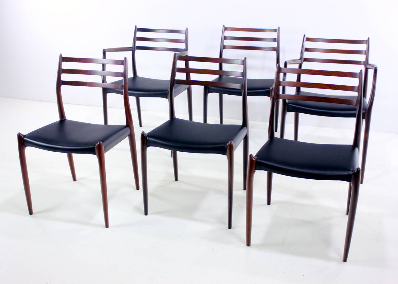 Six Danish modern dining chairs designed by Niels Moller.
Extraordinary rosewood frames formed with graceful, dynamic tapers and curves throughout.
Highest quality craftsmanship.
Includes two armchairs measuring 21.5