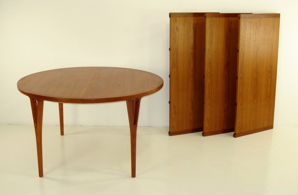 Elegant,versatile danish modern dining table.

Features three 22.75