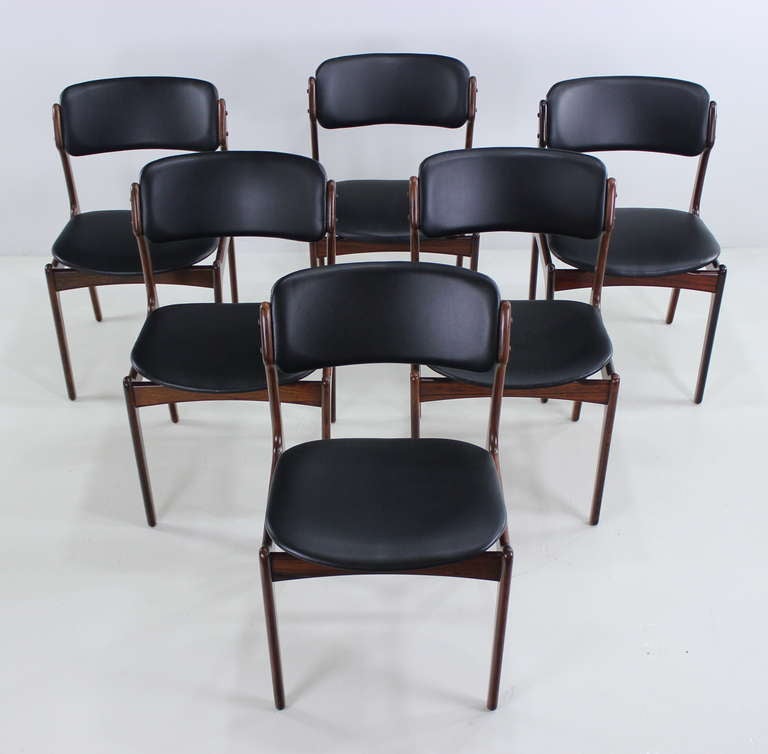 Six Danish modern dining chairs designed by Erik Buck.

Highest quality style and craftsmanship with beautifully detailed joinery and floating seats.

Rich rosewood frames with seats and backs newly upholstered in, black, leather-like